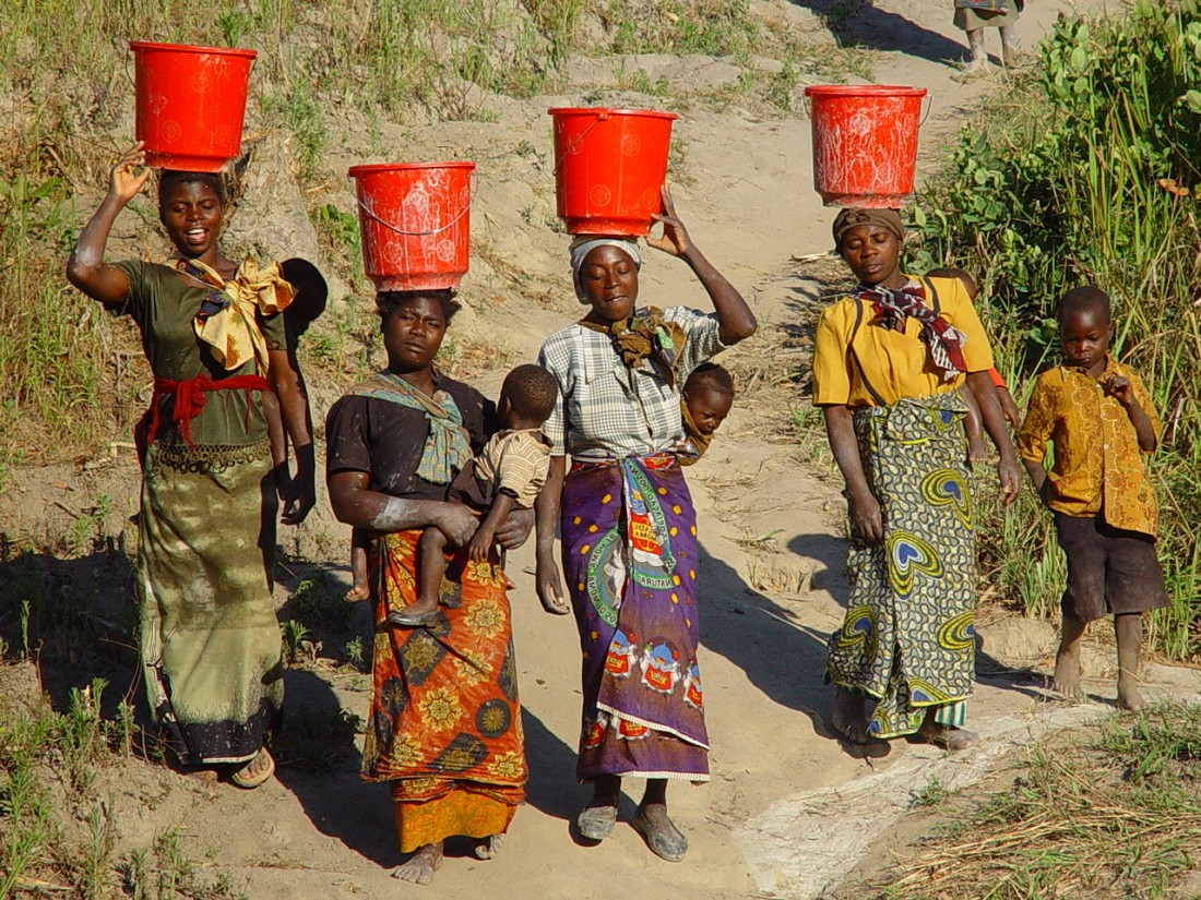 Women walking to well for water